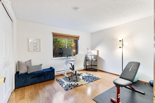 office with hardwood / wood-style flooring and a textured ceiling