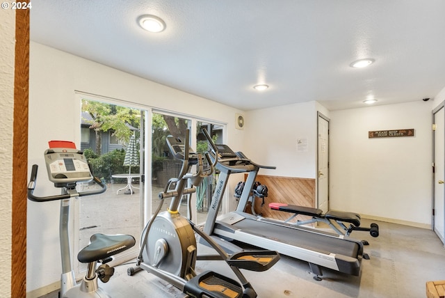 exercise room with a textured ceiling