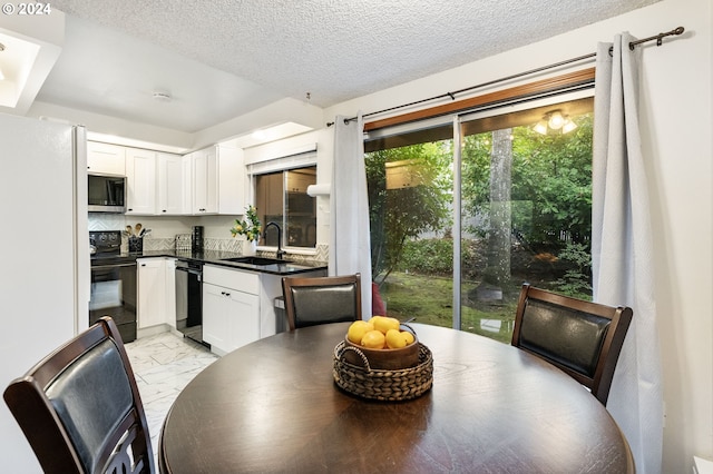 dining room with sink and a textured ceiling