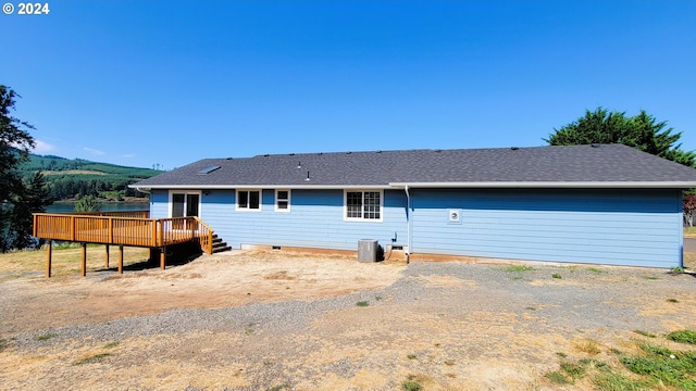 rear view of property with a wooden deck and central AC