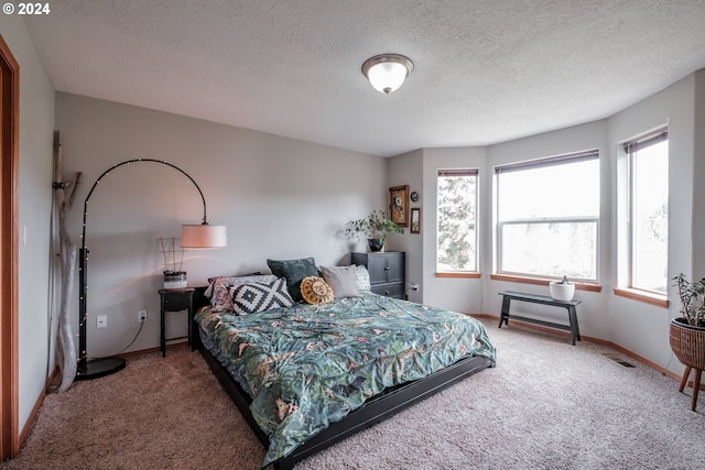 carpeted bedroom with a textured ceiling