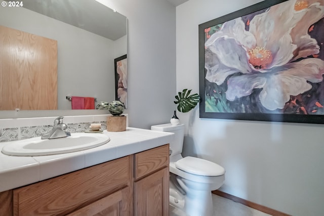 bathroom featuring toilet and vanity