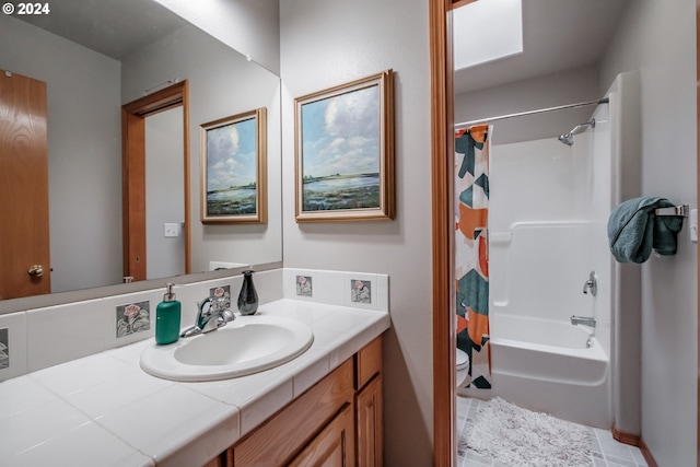 bathroom with shower / tub combo and vanity