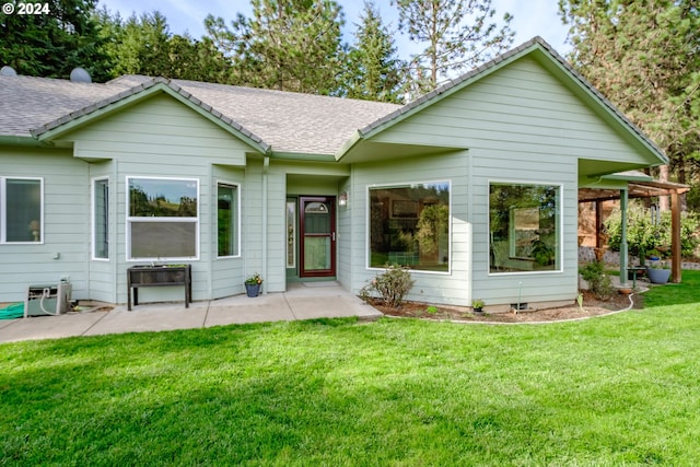 back of house featuring ac unit, a lawn, and a patio area