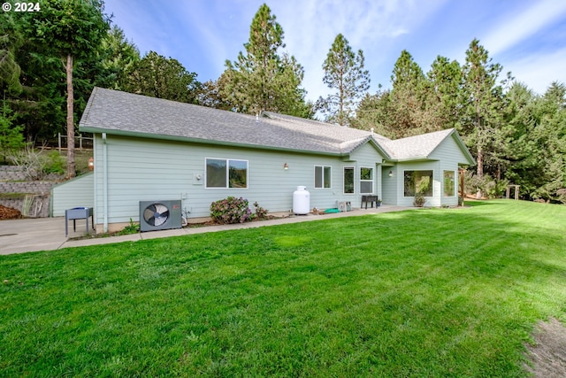 back of property featuring ac unit, a patio area, and a yard