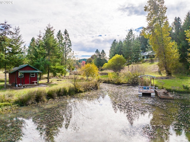 view of yard featuring an outbuilding and a water view