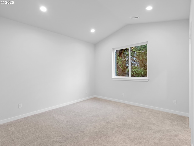 empty room with lofted ceiling, recessed lighting, visible vents, carpet flooring, and baseboards