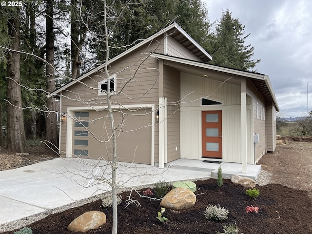 view of front of property featuring a garage and concrete driveway