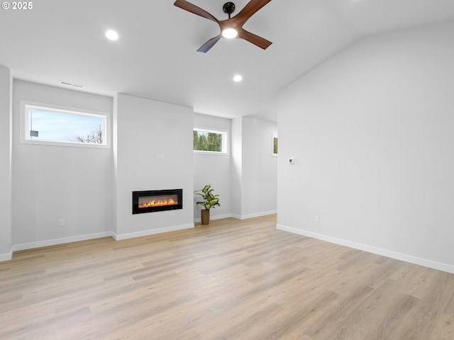 unfurnished living room featuring baseboards, a ceiling fan, a glass covered fireplace, light wood-style flooring, and recessed lighting