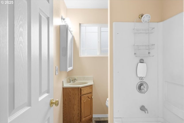 full bathroom featuring shower / bathing tub combination, vanity, and toilet