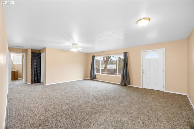 unfurnished living room featuring ceiling fan and carpet floors