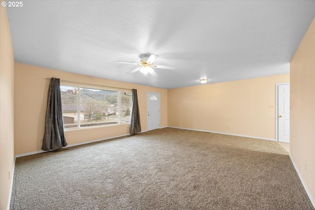 carpeted empty room with a textured ceiling and ceiling fan