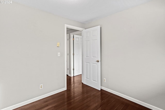 empty room with dark hardwood / wood-style floors