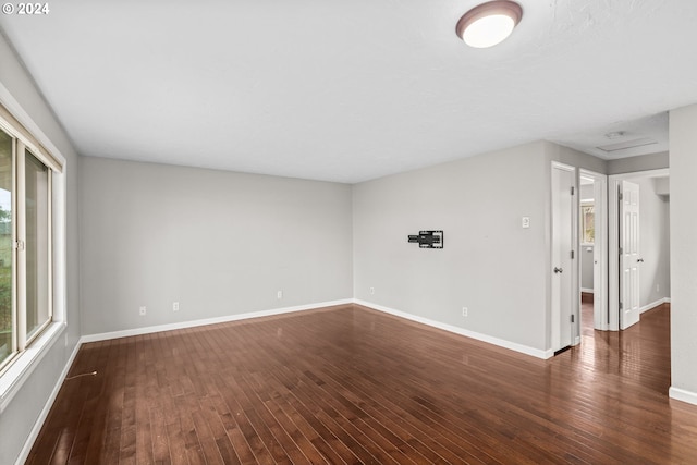 unfurnished room with dark hardwood / wood-style floors and a wealth of natural light