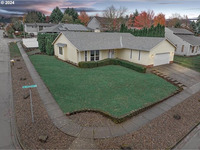 single story home with a yard and a garage