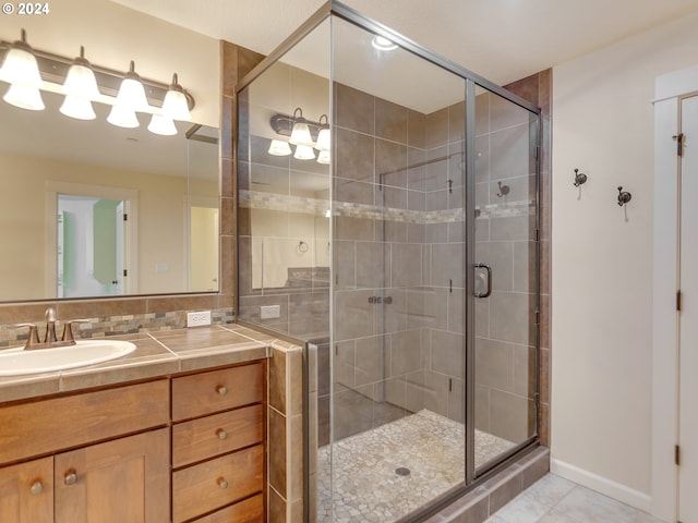 bathroom featuring vanity and a shower with door