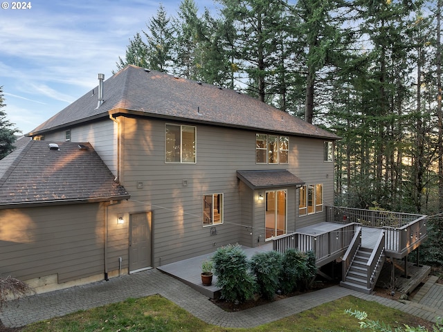 rear view of house with a wooden deck