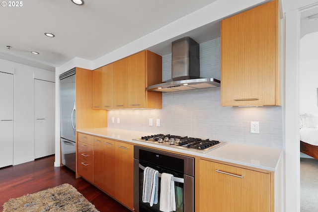 kitchen with dark wood-type flooring, stainless steel appliances, tasteful backsplash, and wall chimney exhaust hood