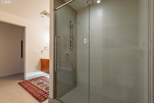 bathroom with tile patterned floors and walk in shower