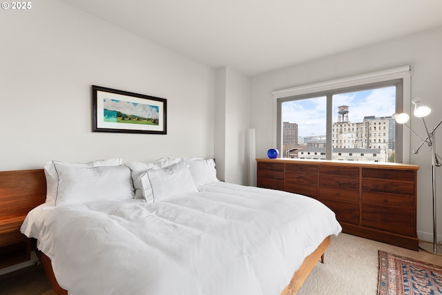 bedroom featuring light colored carpet