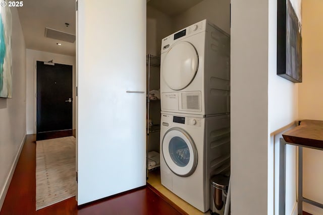 laundry room with stacked washer / drying machine