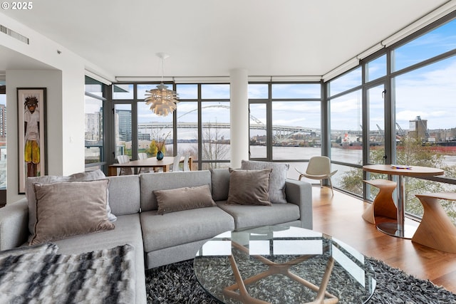 sunroom / solarium featuring an inviting chandelier and a wealth of natural light