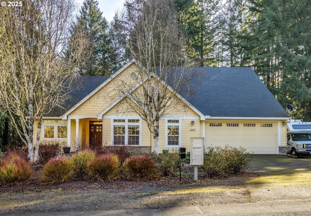 view of front of home featuring a garage, stone siding, concrete driveway, and a shingled roof