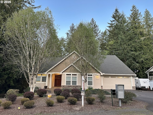 craftsman-style house featuring an attached garage, driveway, stone siding, and roof with shingles