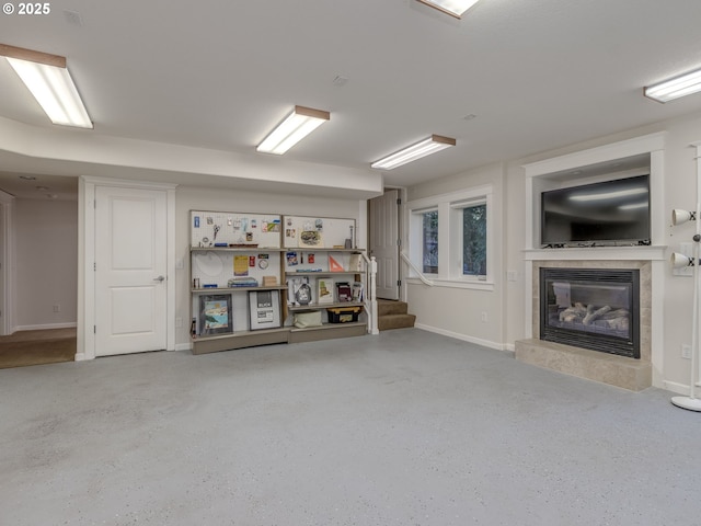 below grade area featuring stairs, baseboards, and a tile fireplace