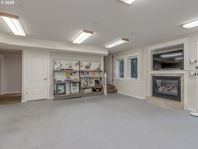 below grade area featuring baseboards, a fireplace, and stairs