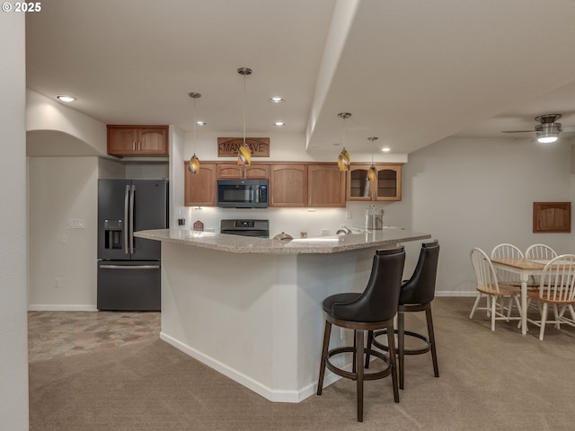 kitchen featuring stainless steel electric range, recessed lighting, black microwave, fridge with ice dispenser, and light colored carpet