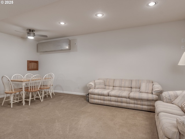 carpeted living area featuring recessed lighting, baseboards, ceiling fan, and a wall unit AC