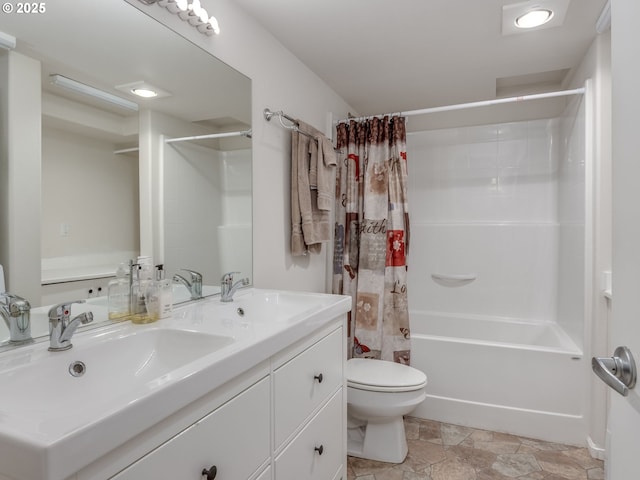 full bath featuring stone finish flooring, toilet, double vanity, shower / bathtub combination with curtain, and a sink