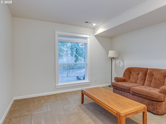 living room with visible vents, baseboards, recessed lighting, and light colored carpet