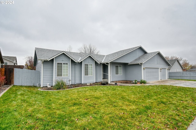 single story home with a garage and a front lawn