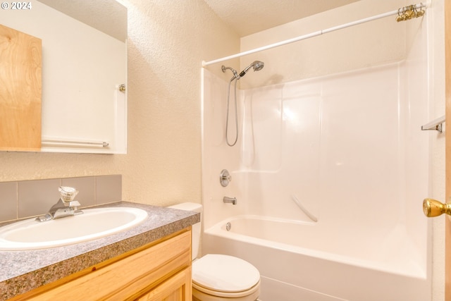 full bathroom with vanity, shower / bath combination, a textured ceiling, and toilet