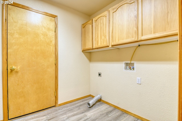 clothes washing area with electric dryer hookup, light hardwood / wood-style floors, cabinets, and hookup for a washing machine