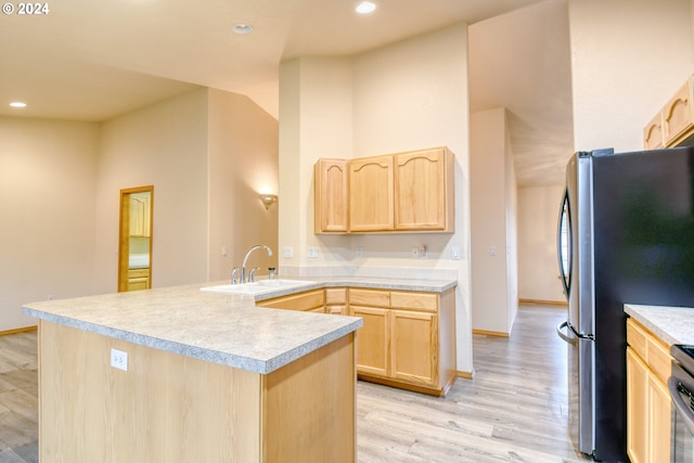 kitchen with sink, light brown cabinets, appliances with stainless steel finishes, and light wood-type flooring