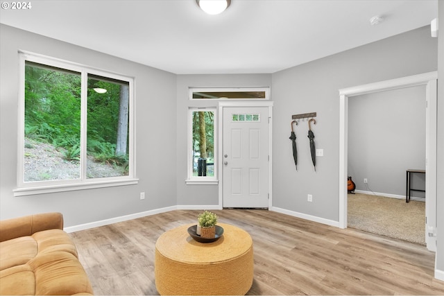 foyer featuring light wood-style flooring and baseboards