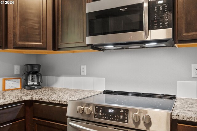 kitchen with dark brown cabinetry and stainless steel appliances