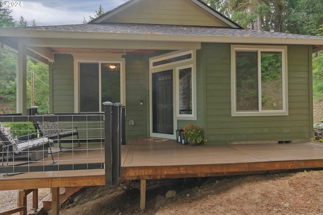 rear view of property featuring a deck