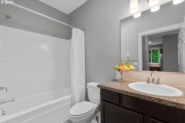 full bath featuring shower / bath combo, vanity, and toilet