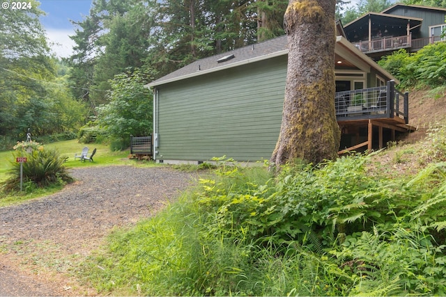 view of side of home with driveway and crawl space