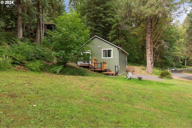 view of grassy yard with a deck