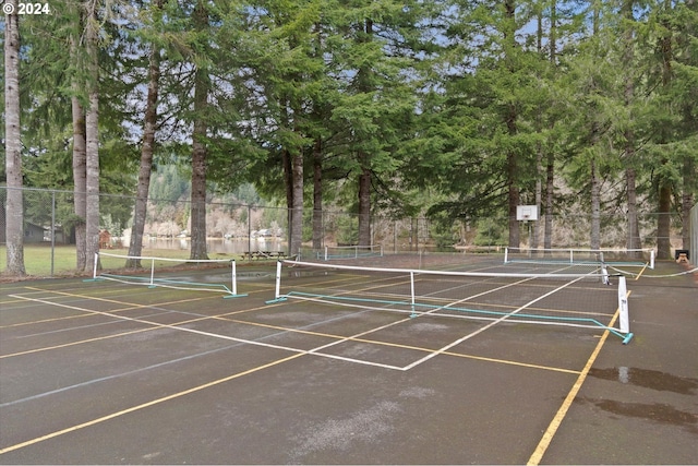 view of tennis court featuring fence