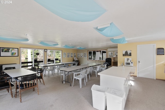 dining area featuring light colored carpet