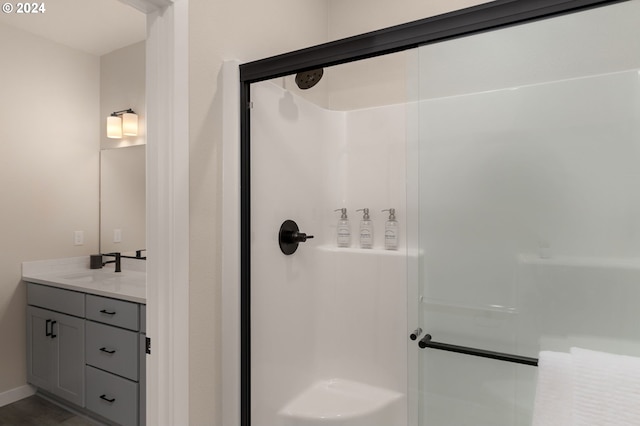 bathroom featuring vanity and a shower with shower door