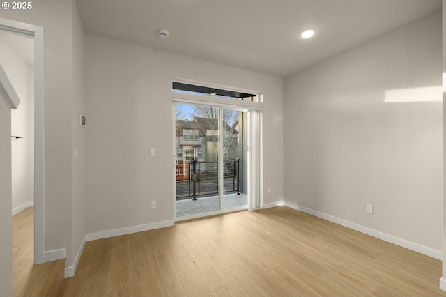 empty room with recessed lighting, baseboards, and light wood-type flooring