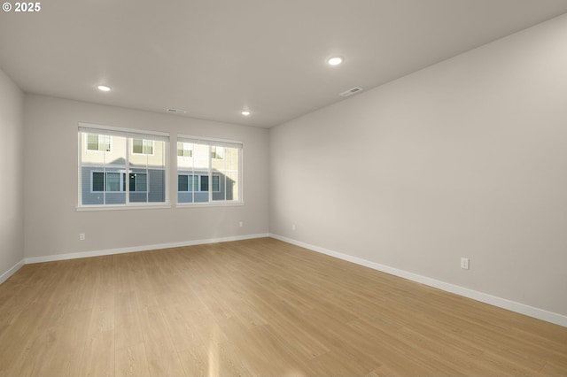 unfurnished room featuring visible vents, recessed lighting, light wood-type flooring, and baseboards