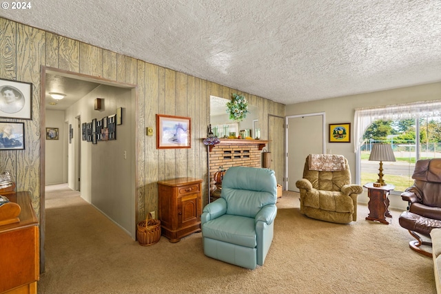 living area featuring a brick fireplace, carpet, and a textured ceiling